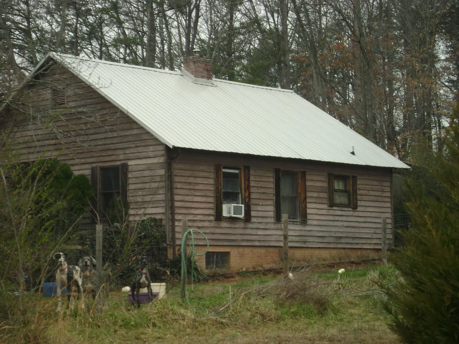 White metal roof on an old wood sided farmhouse, from a Metal Roof Installation job in New Germany